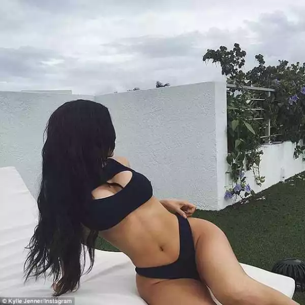 Kylie Jenner flaunts her figure in a tight bikini as she poses for a photoshoot